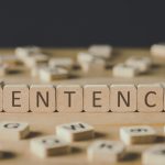 selective focus of cubes with word sentence surrounded by blocks with letters on wooden surface